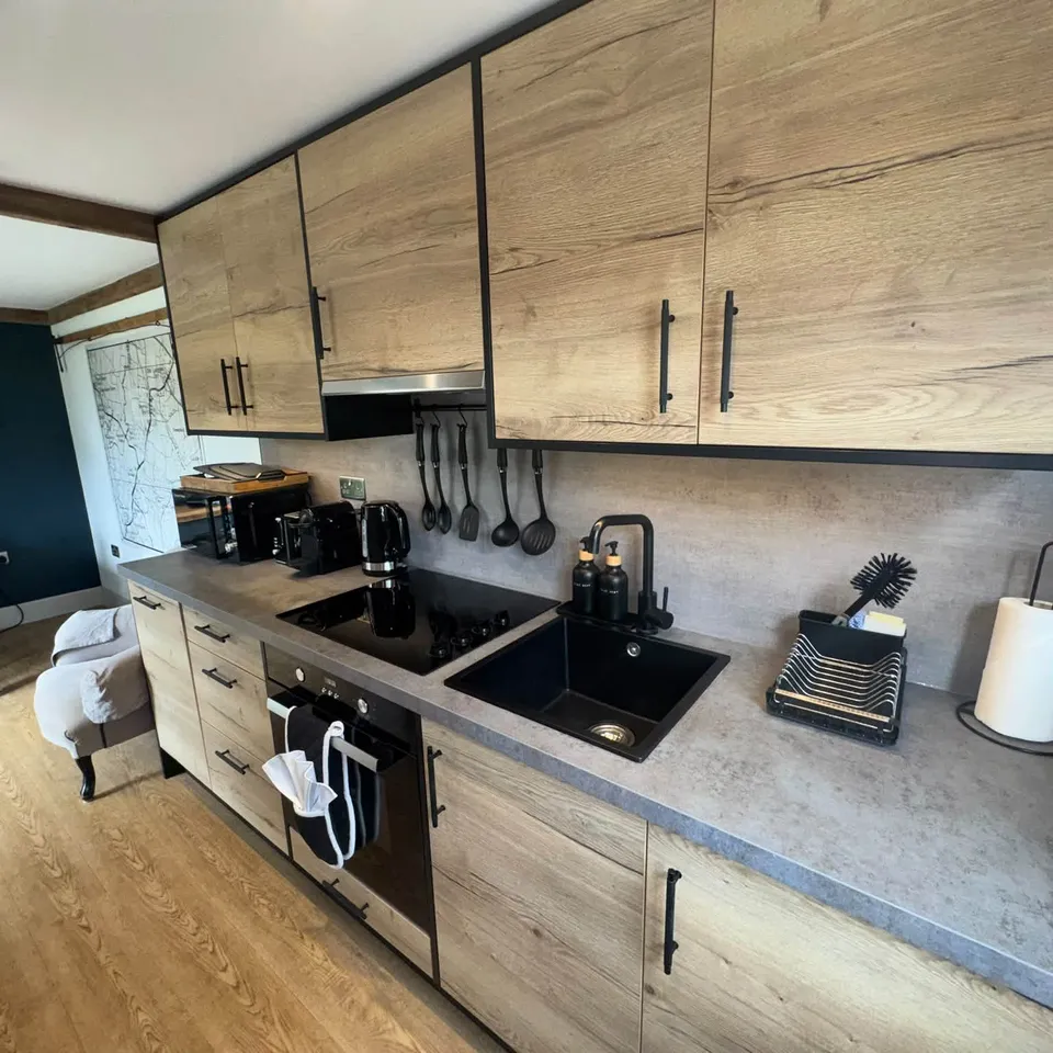 A bright oak kitchen in Kent after a Polka Dot Cleaners clean, with clear worktops and a spotless hob